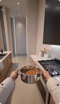 Real kitchen from an egocentric camera, hands holding a pot