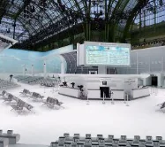 A fashion show set under a glass roof